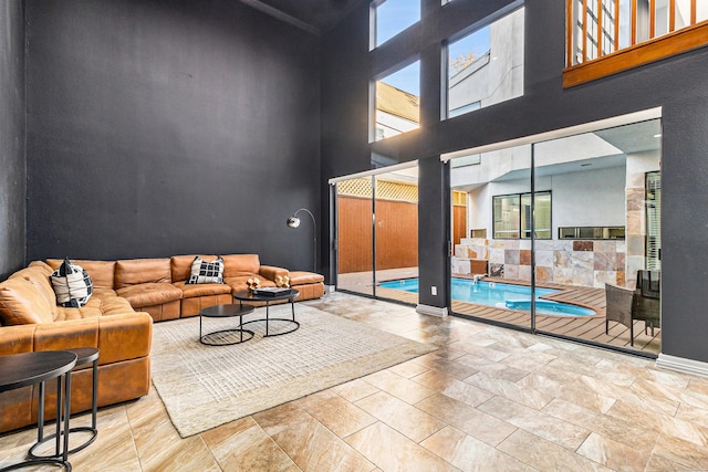 living room featuring a towering ceiling