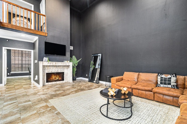 living room featuring crown molding and a high ceiling