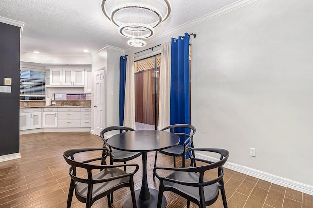 dining area featuring a notable chandelier, crown molding, and a textured ceiling