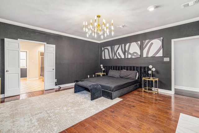 bedroom featuring crown molding, hardwood / wood-style flooring, and an inviting chandelier