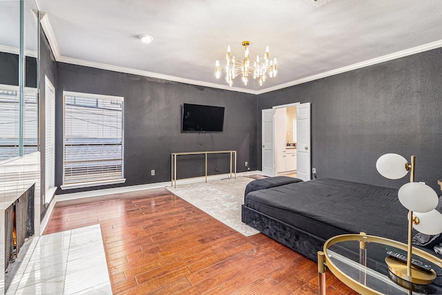 bedroom featuring crown molding, wood-type flooring, and an inviting chandelier