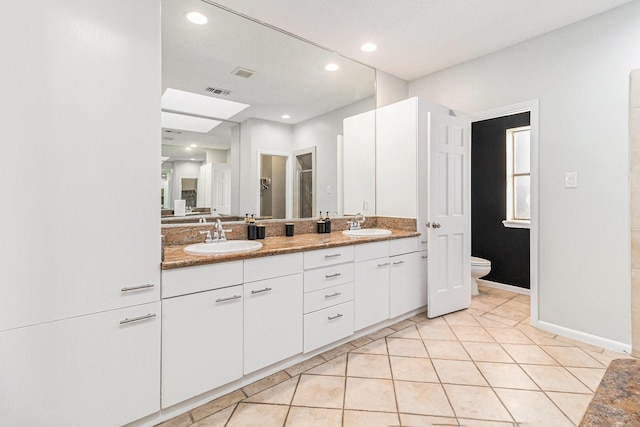 bathroom featuring tile patterned floors, toilet, and vanity