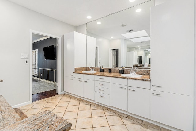 bathroom with vanity and tile patterned flooring