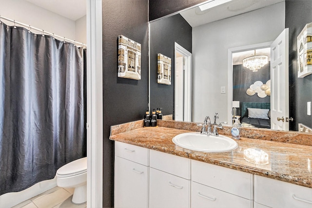 bathroom featuring tile patterned floors, toilet, and vanity