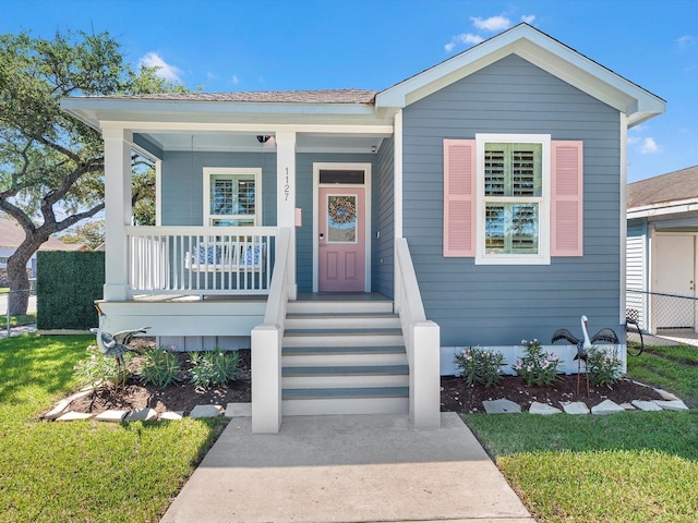 view of front facade with a porch and a front lawn