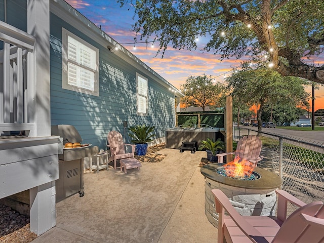 patio terrace at dusk featuring an outdoor fire pit