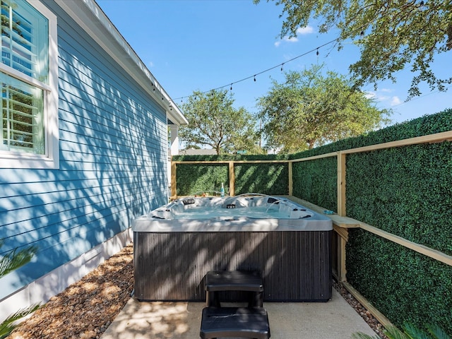 wooden deck with grilling area and a hot tub