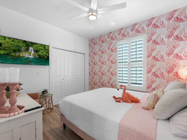 bedroom featuring wood-type flooring, a closet, and ceiling fan