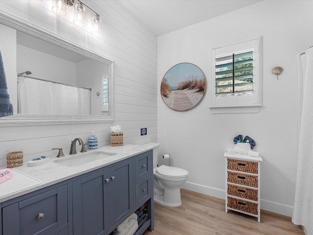 bathroom with wood-type flooring, toilet, and vanity