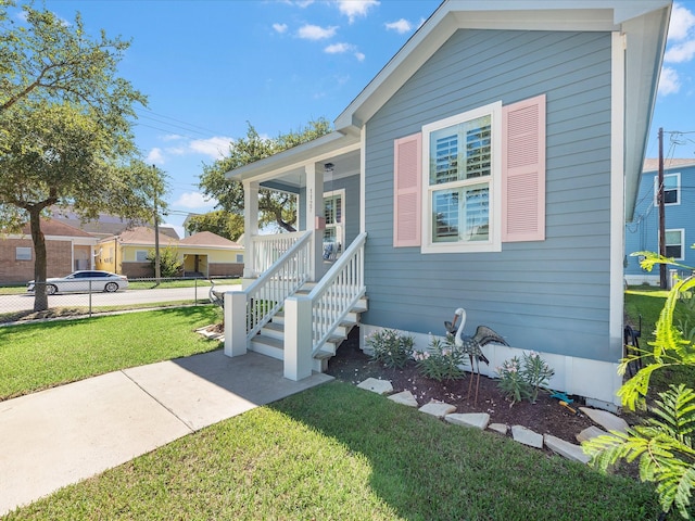 view of front of house featuring a front yard and a porch