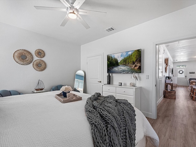 bedroom with ceiling fan and light wood-type flooring