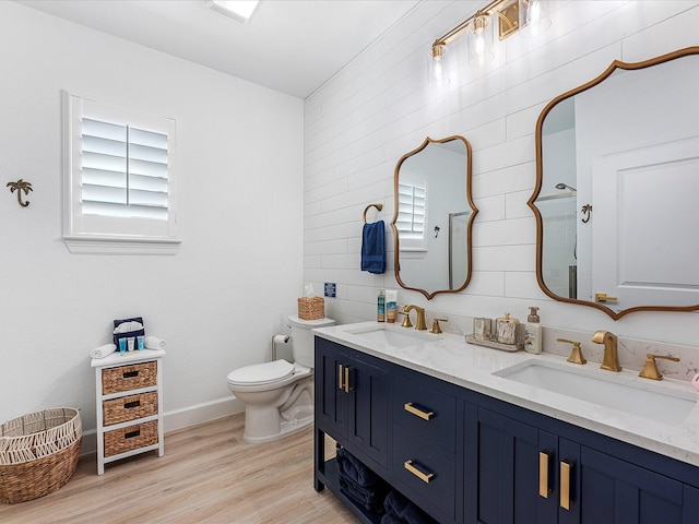 bathroom with vanity, toilet, and hardwood / wood-style floors