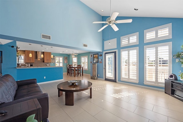 tiled living room featuring a high ceiling and ceiling fan