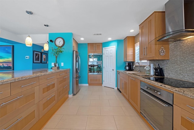 kitchen featuring light stone counters, black electric stovetop, decorative backsplash, decorative light fixtures, and wall chimney exhaust hood