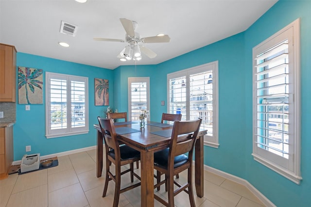 dining area with ceiling fan and light tile patterned flooring