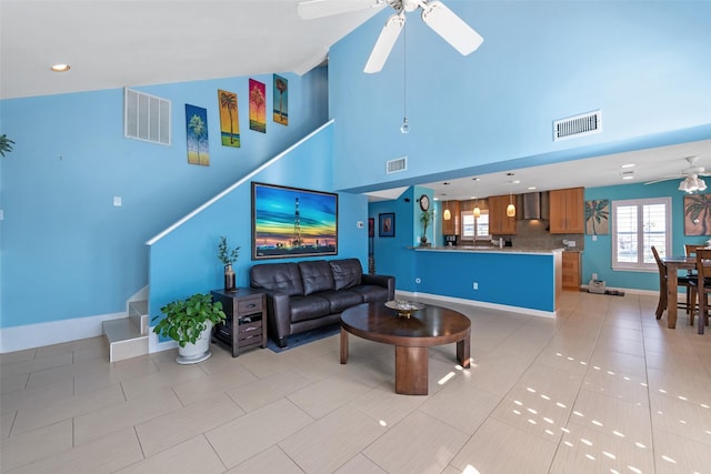 living room featuring light tile patterned floors, high vaulted ceiling, and ceiling fan