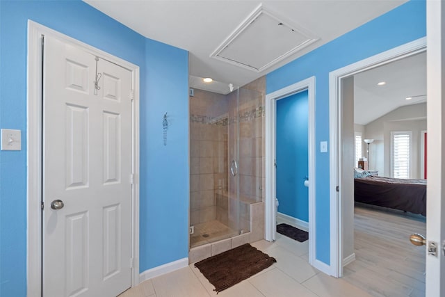 bathroom featuring vaulted ceiling, walk in shower, toilet, and tile patterned flooring