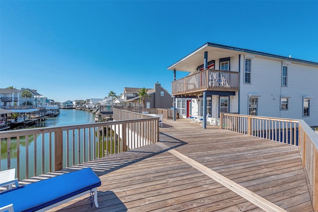 wooden terrace featuring a water view