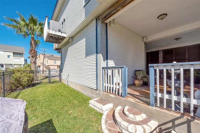 view of side of home featuring a yard and a patio area