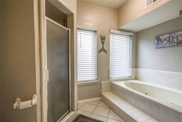 bathroom with separate shower and tub and tile patterned flooring