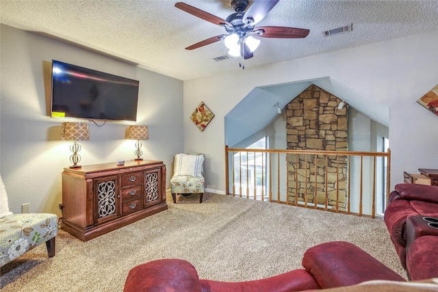 carpeted living room featuring ceiling fan, lofted ceiling, and a textured ceiling