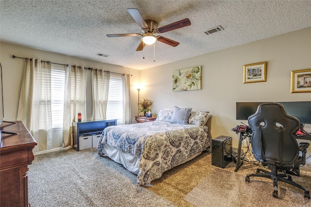 bedroom featuring carpet, a textured ceiling, and ceiling fan