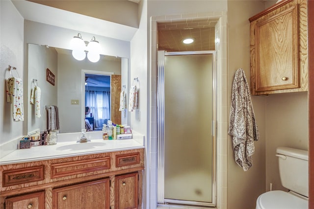 bathroom with vanity, an enclosed shower, and toilet