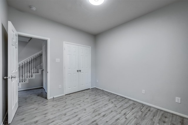 unfurnished bedroom featuring light wood-type flooring