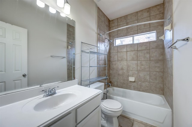 full bathroom featuring tile patterned flooring, tiled shower / bath, vanity, and toilet