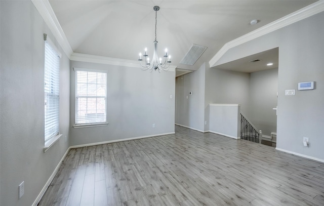 spare room featuring light hardwood / wood-style flooring, vaulted ceiling, ornamental molding, and a chandelier