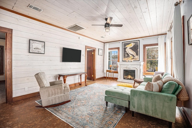 living room featuring crown molding, wood ceiling, wooden walls, and ceiling fan