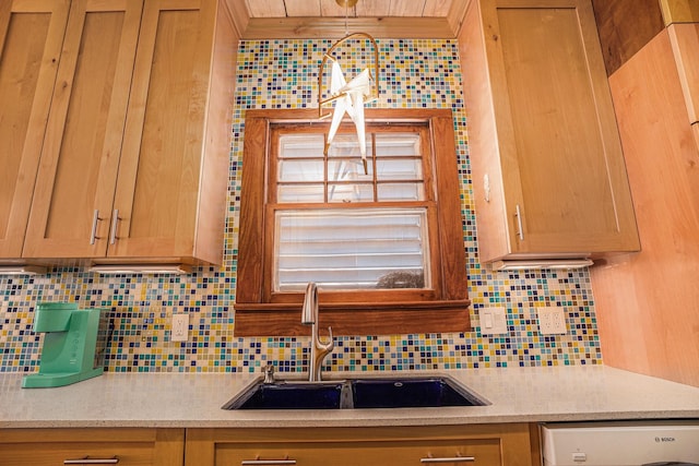 kitchen featuring dishwasher, sink, and decorative backsplash