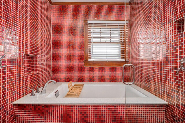 bathroom featuring a washtub and ornamental molding