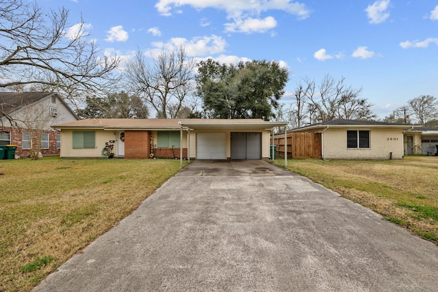 ranch-style home featuring a carport, a garage, and a front yard