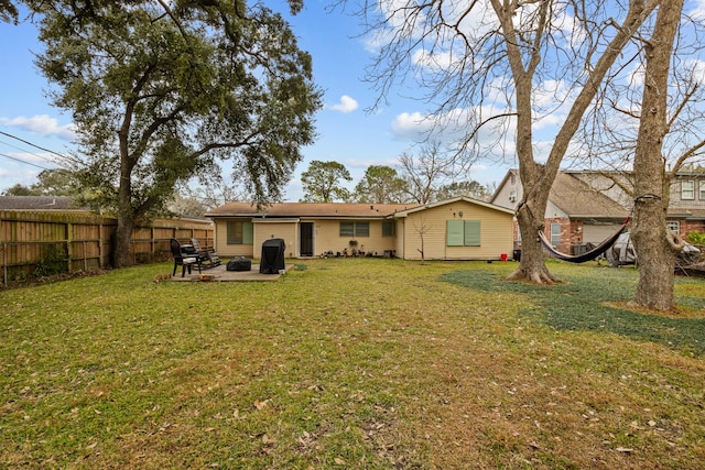 rear view of property with a patio area and a lawn