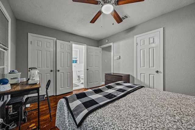 bedroom with dark hardwood / wood-style flooring, connected bathroom, a textured ceiling, and ceiling fan