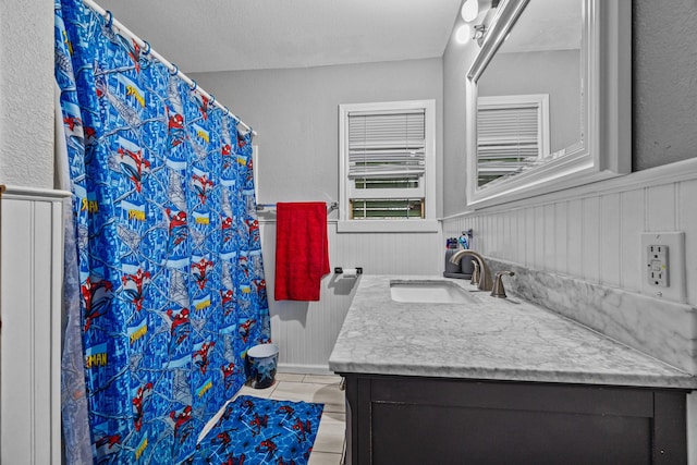 bathroom with vanity, tile patterned flooring, and radiator heating unit