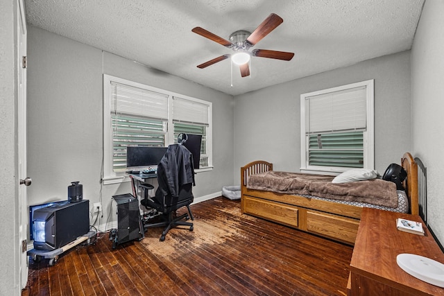 bedroom featuring ceiling fan, hardwood / wood-style floors, and a textured ceiling