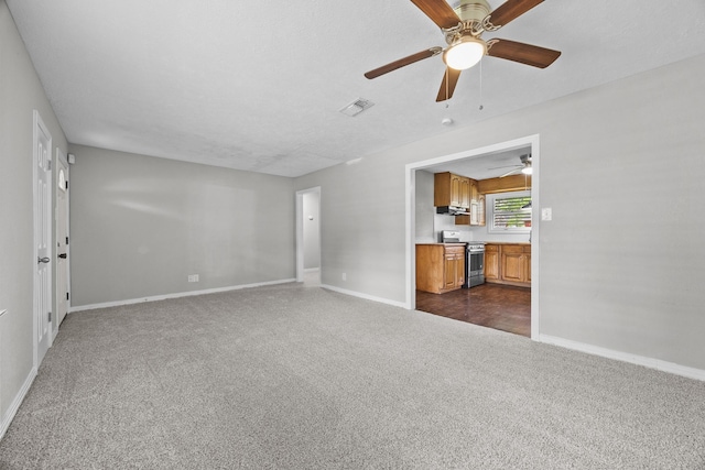 2817 John St, La Marque, TX 77568 - unfurnished living room with a ceiling fan, baseboards, visible vents, and dark carpet