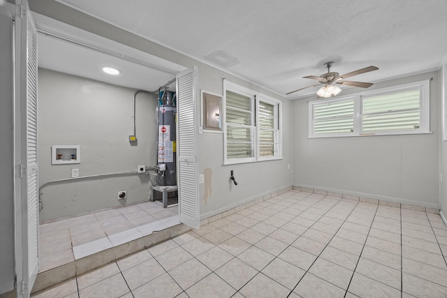 2817 John St, La Marque, TX 77568 - unfurnished room featuring a ceiling fan, light tile patterned floors, and water heater