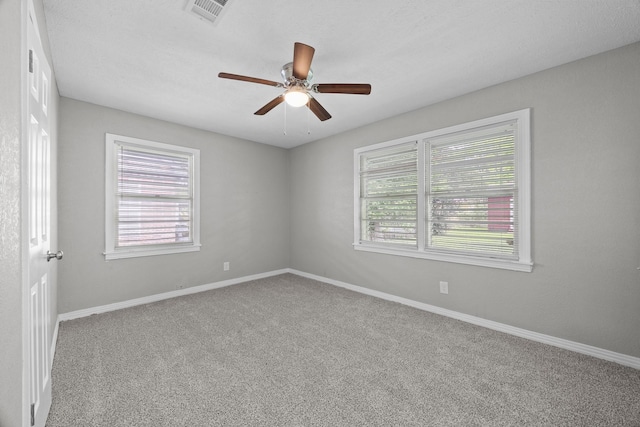 2817 John St, La Marque, TX 77568 - carpeted empty room featuring ceiling fan, visible vents, and baseboards
