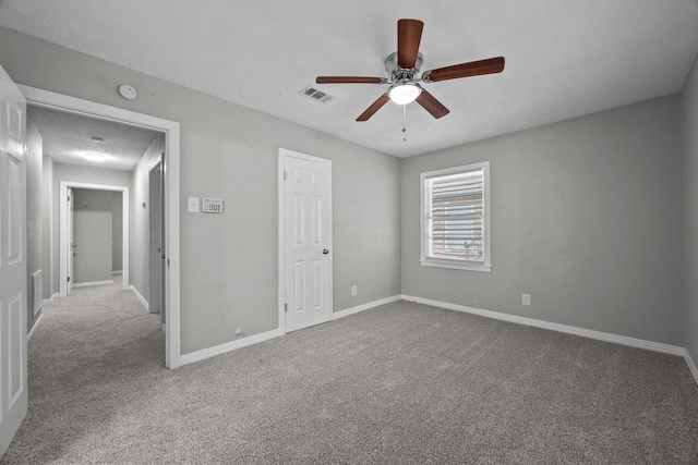 2817 John St, La Marque, TX 77568 - unfurnished bedroom with carpet flooring, a ceiling fan, baseboards, and visible vents