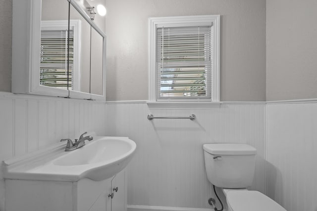 2817 John St, La Marque, TX 77568 - bathroom with toilet, wainscoting, and vanity