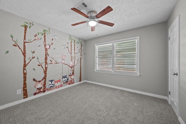 2817 John St, La Marque, TX 77568 - carpeted spare room with baseboards, a ceiling fan, a textured ceiling, and visible vents