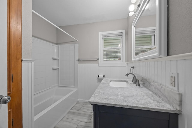 2817 John St, La Marque, TX 77568 - bathroom featuring a wainscoted wall, shower / bathing tub combination, and vanity