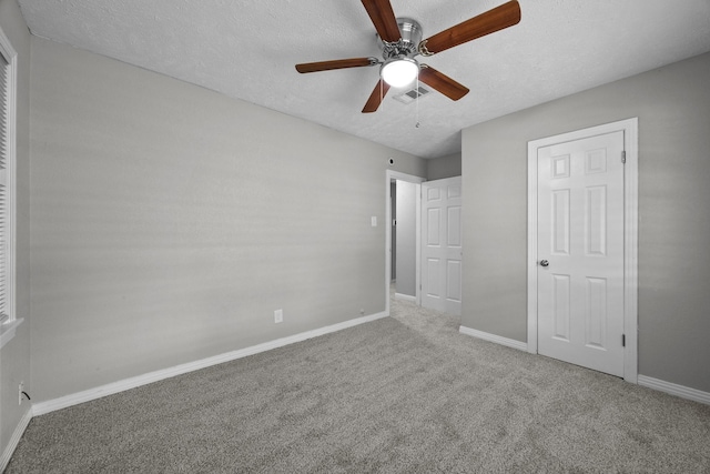 2817 John St, La Marque, TX 77568 - unfurnished bedroom featuring carpet floors, baseboards, a textured ceiling, and visible vents