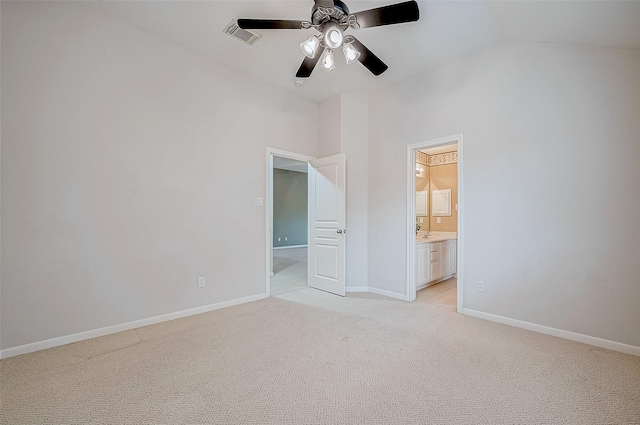 unfurnished bedroom featuring ceiling fan, ensuite bathroom, high vaulted ceiling, and light colored carpet