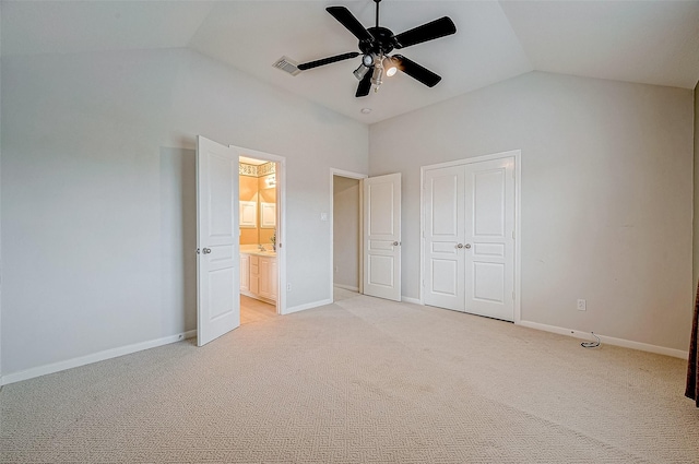 unfurnished bedroom with ceiling fan, lofted ceiling, light colored carpet, and a closet