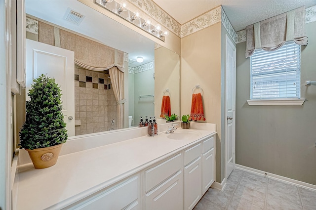 bathroom featuring vanity and a tile shower