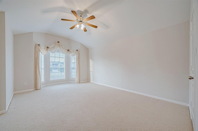 carpeted spare room featuring ceiling fan and lofted ceiling